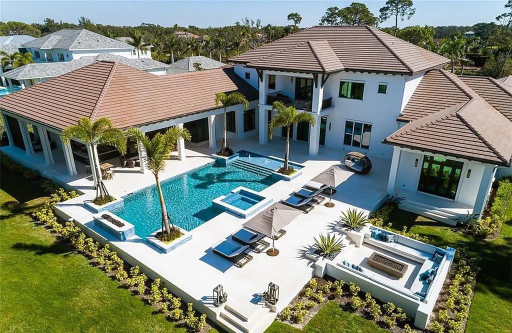 Welcome to 149 Cajeput Drive, Naples, Florida - a newly constructed masterpiece of timeless elegance. This exceptional estate boasts 5 bedrooms, 8 bathrooms, and spans 9,833 square feet.