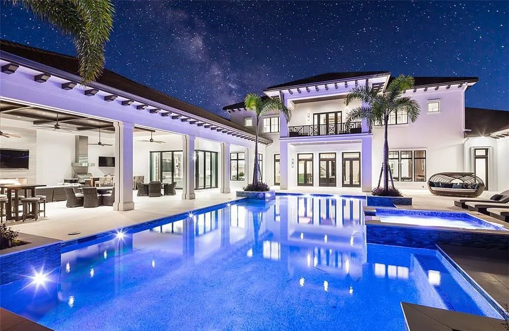 Welcome to 149 Cajeput Drive, Naples, Florida - a newly constructed masterpiece of timeless elegance. This exceptional estate boasts 5 bedrooms, 8 bathrooms, and spans 9,833 square feet.