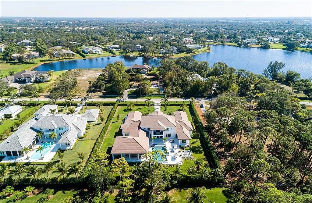 Welcome to 149 Cajeput Drive, Naples, Florida - a newly constructed masterpiece of timeless elegance. This exceptional estate boasts 5 bedrooms, 8 bathrooms, and spans 9,833 square feet.