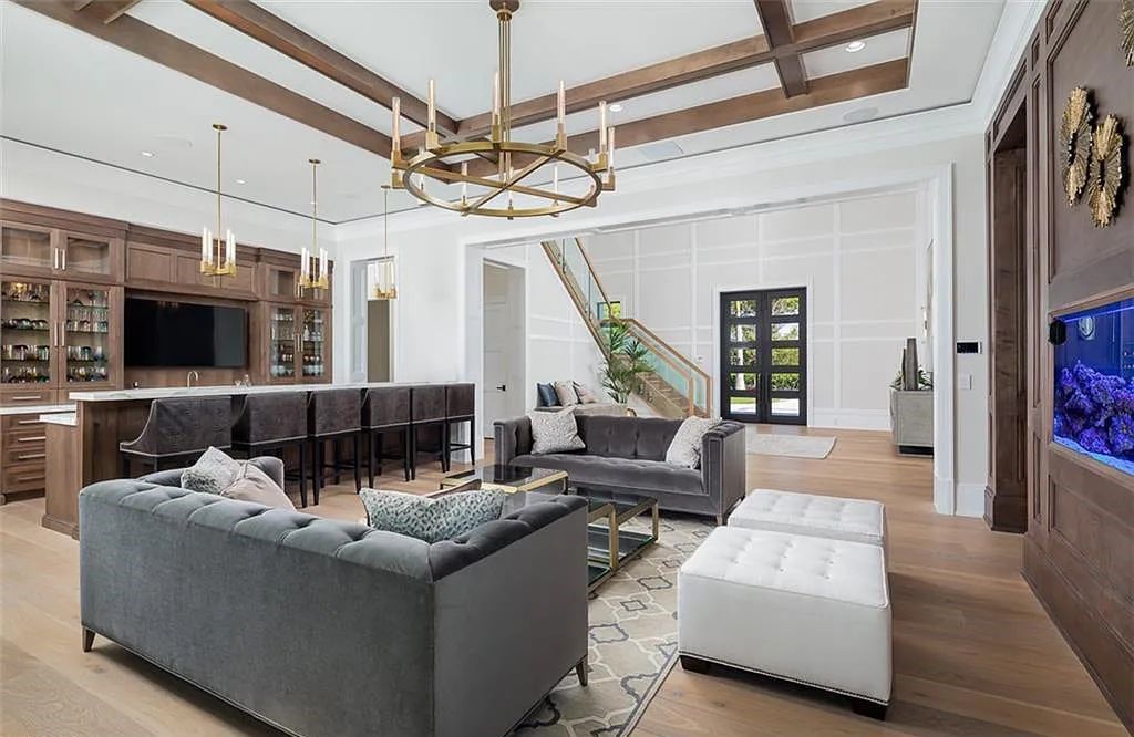 Welcome to 149 Cajeput Drive, Naples, Florida - a newly constructed masterpiece of timeless elegance. This exceptional estate boasts 5 bedrooms, 8 bathrooms, and spans 9,833 square feet.
