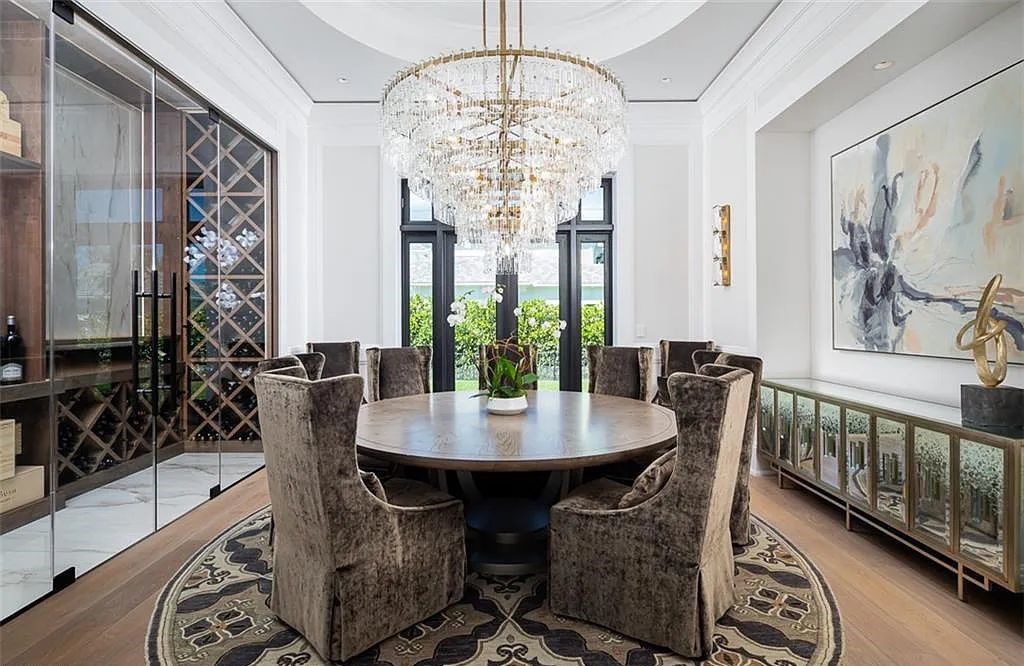 Welcome to 149 Cajeput Drive, Naples, Florida - a newly constructed masterpiece of timeless elegance. This exceptional estate boasts 5 bedrooms, 8 bathrooms, and spans 9,833 square feet.