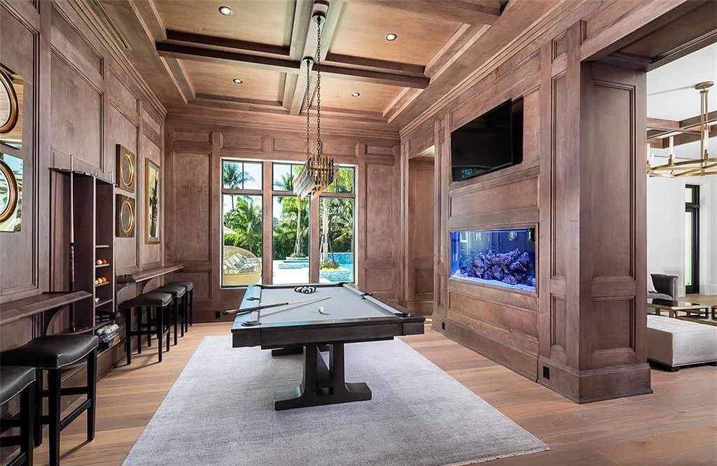 Welcome to 149 Cajeput Drive, Naples, Florida - a newly constructed masterpiece of timeless elegance. This exceptional estate boasts 5 bedrooms, 8 bathrooms, and spans 9,833 square feet.