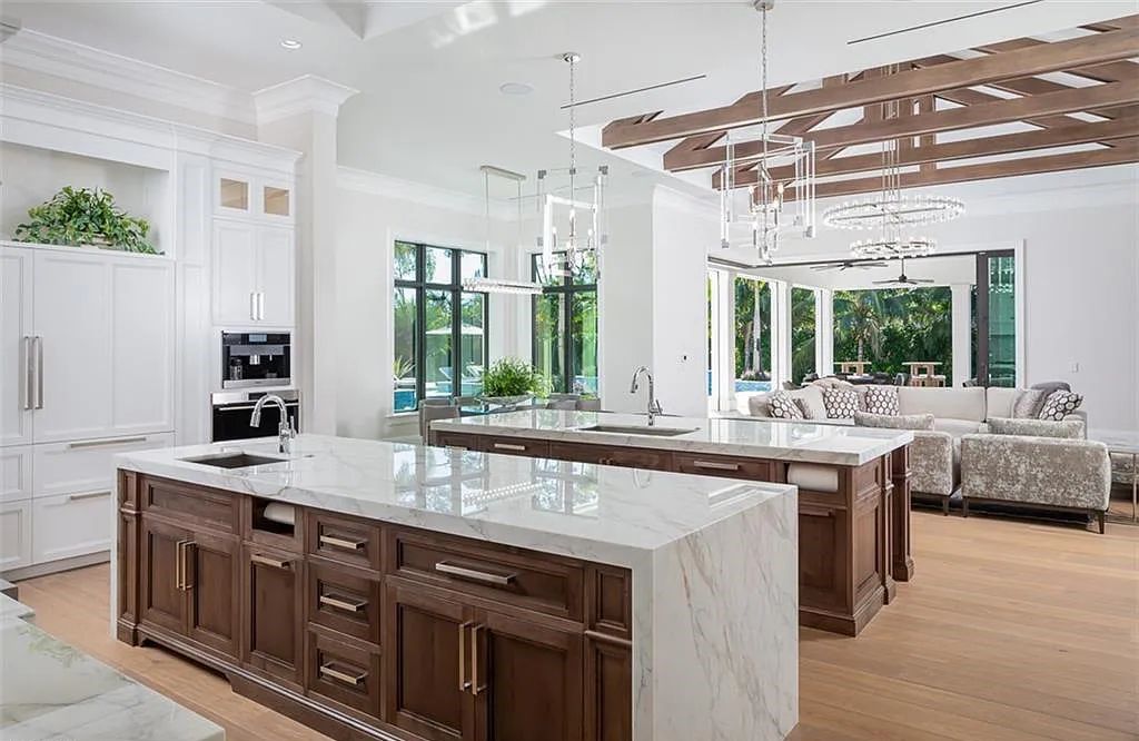 Welcome to 149 Cajeput Drive, Naples, Florida - a newly constructed masterpiece of timeless elegance. This exceptional estate boasts 5 bedrooms, 8 bathrooms, and spans 9,833 square feet.