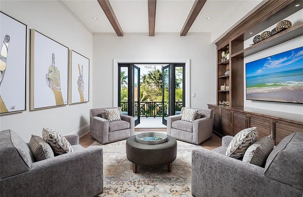 Welcome to 149 Cajeput Drive, Naples, Florida - a newly constructed masterpiece of timeless elegance. This exceptional estate boasts 5 bedrooms, 8 bathrooms, and spans 9,833 square feet.