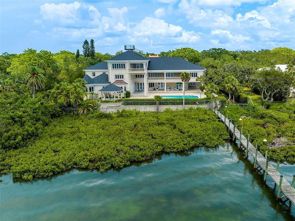 Discover 1405 Kimlira Lane, an exquisite Bayfront estate in Sarasota, Florida. Situated on 1.1 acres with 170 ft of shoreline, this 12,724 square feet masterpiece offers unparalleled luxury.