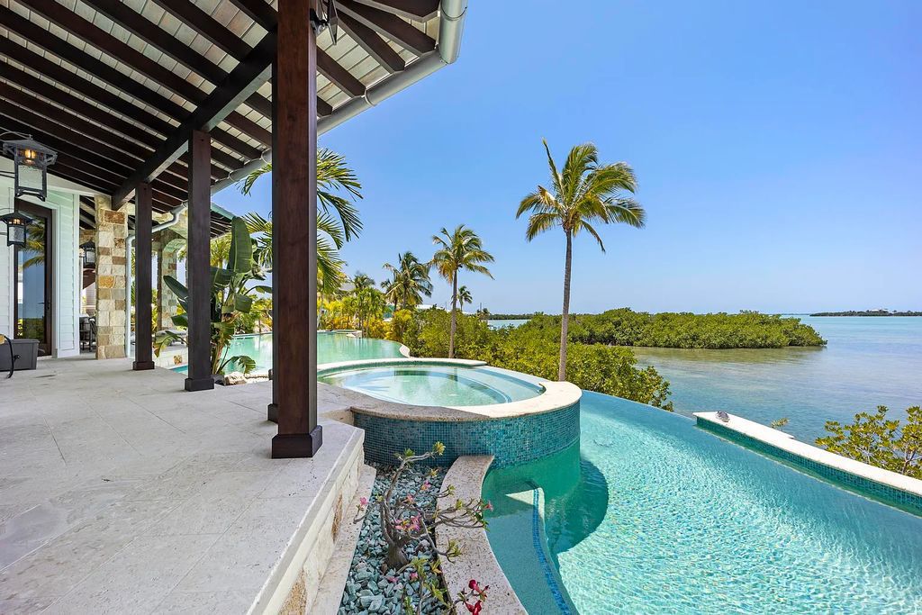 Introducing 1300 Sunset Boulevard, Tarpon Ranch—an elegant private estate in Summerland Key, Florida. Just minutes from Key West, this luxurious property offers relaxed coastal living at its finest. With 6 bedrooms, 8 bathrooms, and 7,720 square feet of living space on a 1.35-acre lot, it's a masterpiece of architectural splendor.