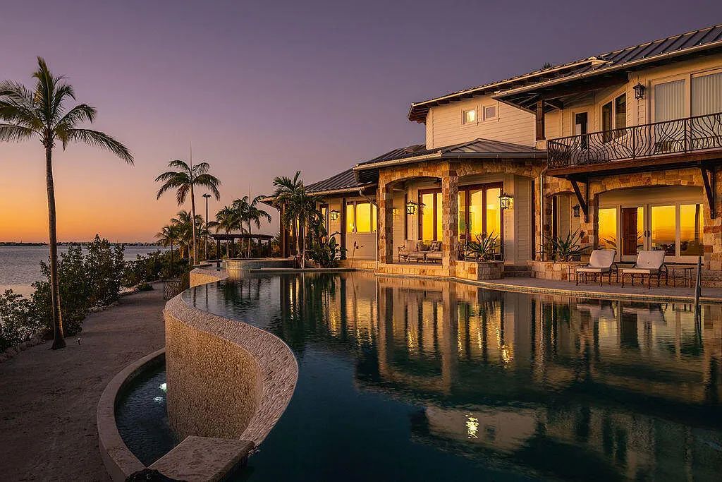 Introducing 1300 Sunset Boulevard, Tarpon Ranch—an elegant private estate in Summerland Key, Florida. Just minutes from Key West, this luxurious property offers relaxed coastal living at its finest. With 6 bedrooms, 8 bathrooms, and 7,720 square feet of living space on a 1.35-acre lot, it's a masterpiece of architectural splendor.