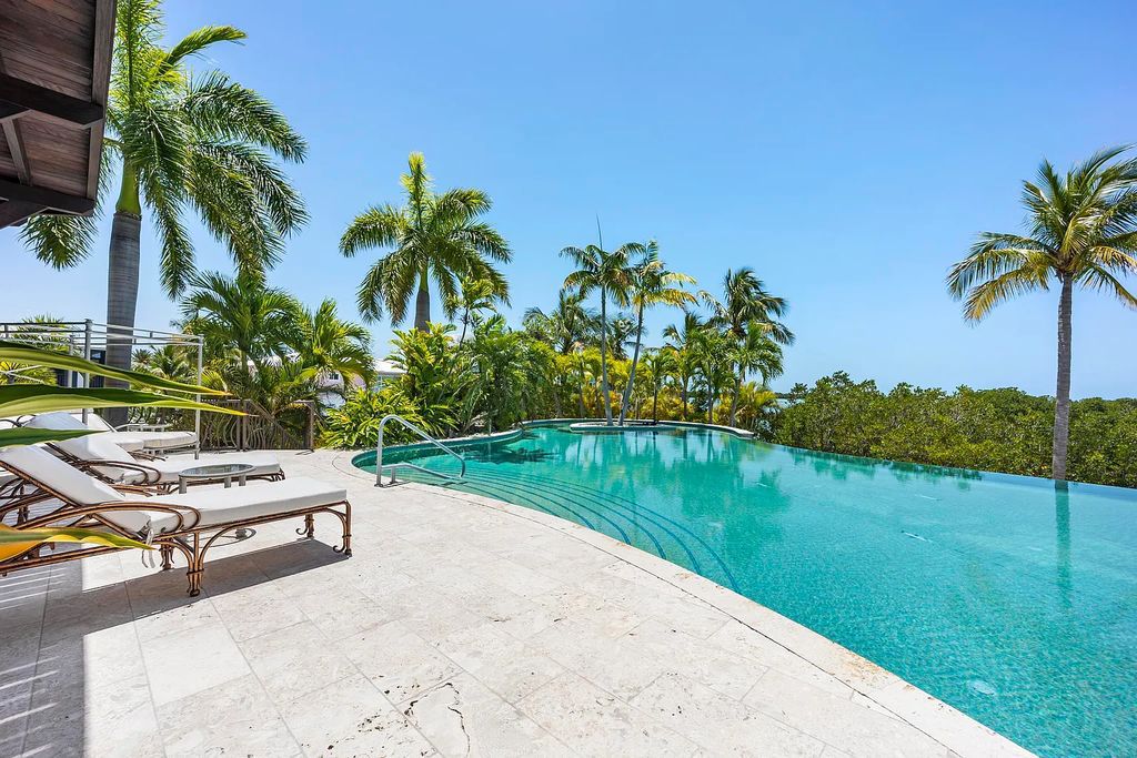 Introducing 1300 Sunset Boulevard, Tarpon Ranch—an elegant private estate in Summerland Key, Florida. Just minutes from Key West, this luxurious property offers relaxed coastal living at its finest. With 6 bedrooms, 8 bathrooms, and 7,720 square feet of living space on a 1.35-acre lot, it's a masterpiece of architectural splendor.