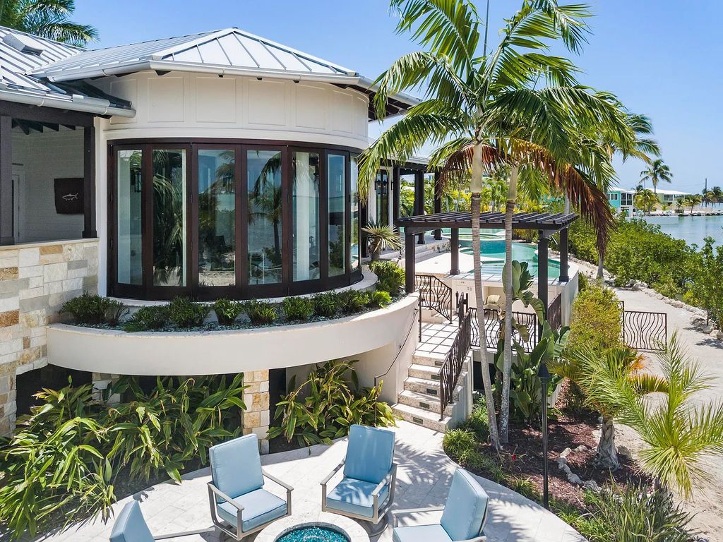 Introducing 1300 Sunset Boulevard, Tarpon Ranch—an elegant private estate in Summerland Key, Florida. Just minutes from Key West, this luxurious property offers relaxed coastal living at its finest. With 6 bedrooms, 8 bathrooms, and 7,720 square feet of living space on a 1.35-acre lot, it's a masterpiece of architectural splendor.