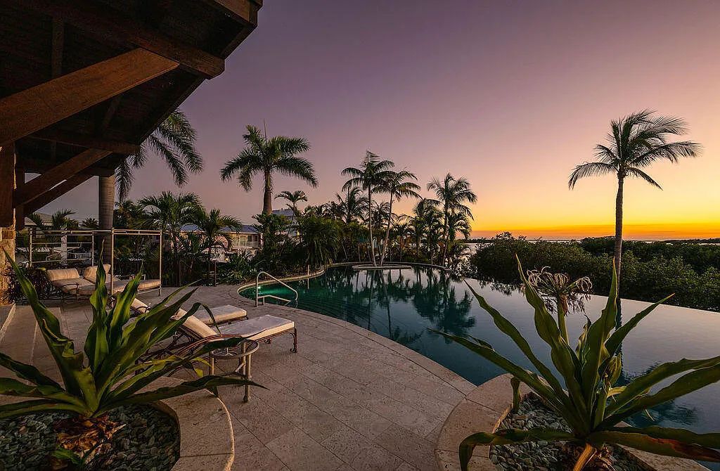 Introducing 1300 Sunset Boulevard, Tarpon Ranch—an elegant private estate in Summerland Key, Florida. Just minutes from Key West, this luxurious property offers relaxed coastal living at its finest. With 6 bedrooms, 8 bathrooms, and 7,720 square feet of living space on a 1.35-acre lot, it's a masterpiece of architectural splendor.