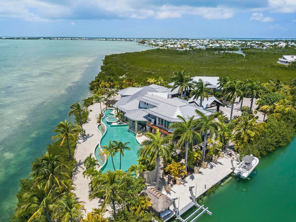 Introducing 1300 Sunset Boulevard, Tarpon Ranch—an elegant private estate in Summerland Key, Florida. Just minutes from Key West, this luxurious property offers relaxed coastal living at its finest. With 6 bedrooms, 8 bathrooms, and 7,720 square feet of living space on a 1.35-acre lot, it's a masterpiece of architectural splendor.