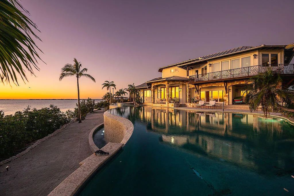 Introducing 1300 Sunset Boulevard, Tarpon Ranch—an elegant private estate in Summerland Key, Florida. Just minutes from Key West, this luxurious property offers relaxed coastal living at its finest. With 6 bedrooms, 8 bathrooms, and 7,720 square feet of living space on a 1.35-acre lot, it's a masterpiece of architectural splendor.