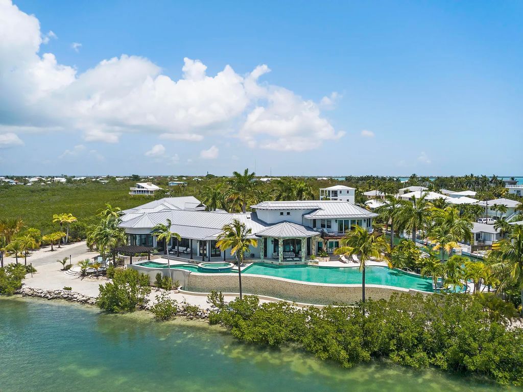 Introducing 1300 Sunset Boulevard, Tarpon Ranch—an elegant private estate in Summerland Key, Florida. Just minutes from Key West, this luxurious property offers relaxed coastal living at its finest. With 6 bedrooms, 8 bathrooms, and 7,720 square feet of living space on a 1.35-acre lot, it's a masterpiece of architectural splendor.