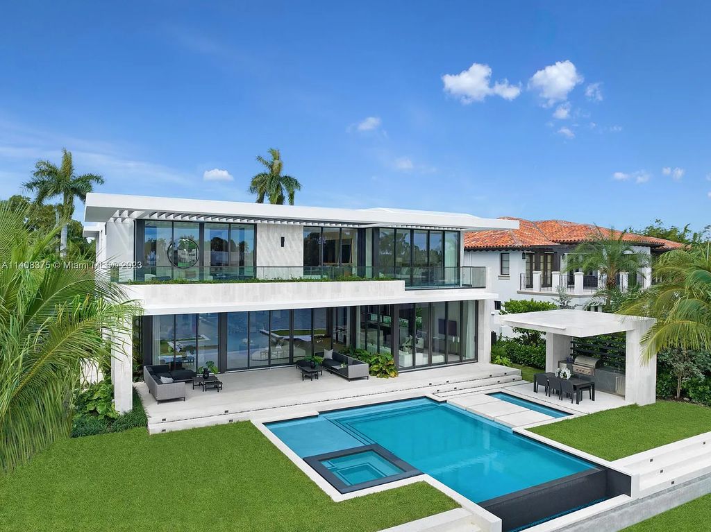 Experience luxury living at its finest in this brand-new custom residence located at 9520 W Broadview Drive, Bay Harbor Islands, Florida. With 8 bedrooms, 10 bathrooms, and over 8,200 square feet of meticulously designed living space, this modern home offers breathtaking open bay views and a seamless indoor-outdoor flow.