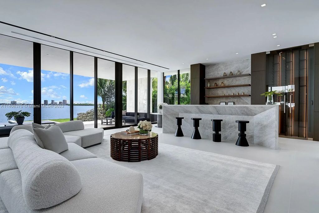 Experience luxury living at its finest in this brand-new custom residence located at 9520 W Broadview Drive, Bay Harbor Islands, Florida. With 8 bedrooms, 10 bathrooms, and over 8,200 square feet of meticulously designed living space, this modern home offers breathtaking open bay views and a seamless indoor-outdoor flow.