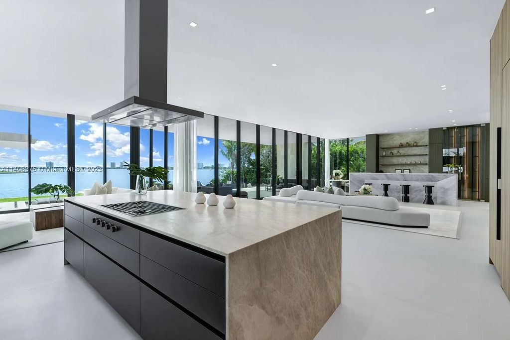 Experience luxury living at its finest in this brand-new custom residence located at 9520 W Broadview Drive, Bay Harbor Islands, Florida. With 8 bedrooms, 10 bathrooms, and over 8,200 square feet of meticulously designed living space, this modern home offers breathtaking open bay views and a seamless indoor-outdoor flow.