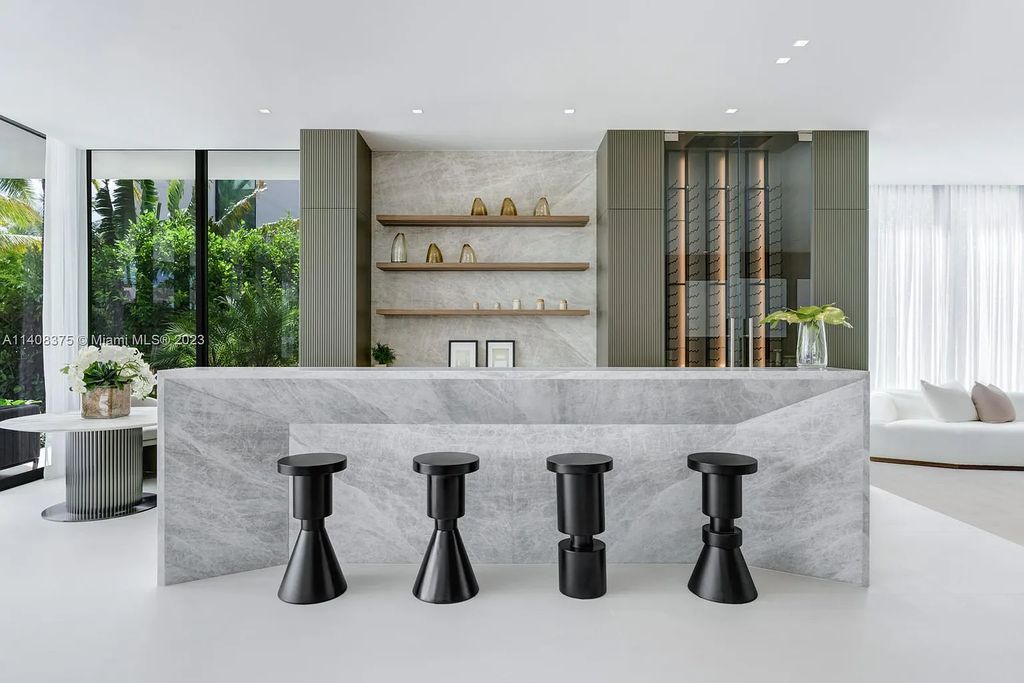 Experience luxury living at its finest in this brand-new custom residence located at 9520 W Broadview Drive, Bay Harbor Islands, Florida. With 8 bedrooms, 10 bathrooms, and over 8,200 square feet of meticulously designed living space, this modern home offers breathtaking open bay views and a seamless indoor-outdoor flow.
