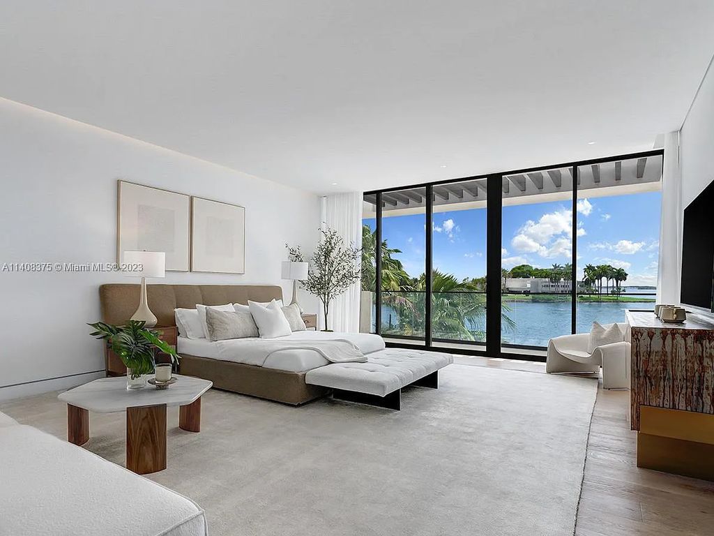 Experience luxury living at its finest in this brand-new custom residence located at 9520 W Broadview Drive, Bay Harbor Islands, Florida. With 8 bedrooms, 10 bathrooms, and over 8,200 square feet of meticulously designed living space, this modern home offers breathtaking open bay views and a seamless indoor-outdoor flow.