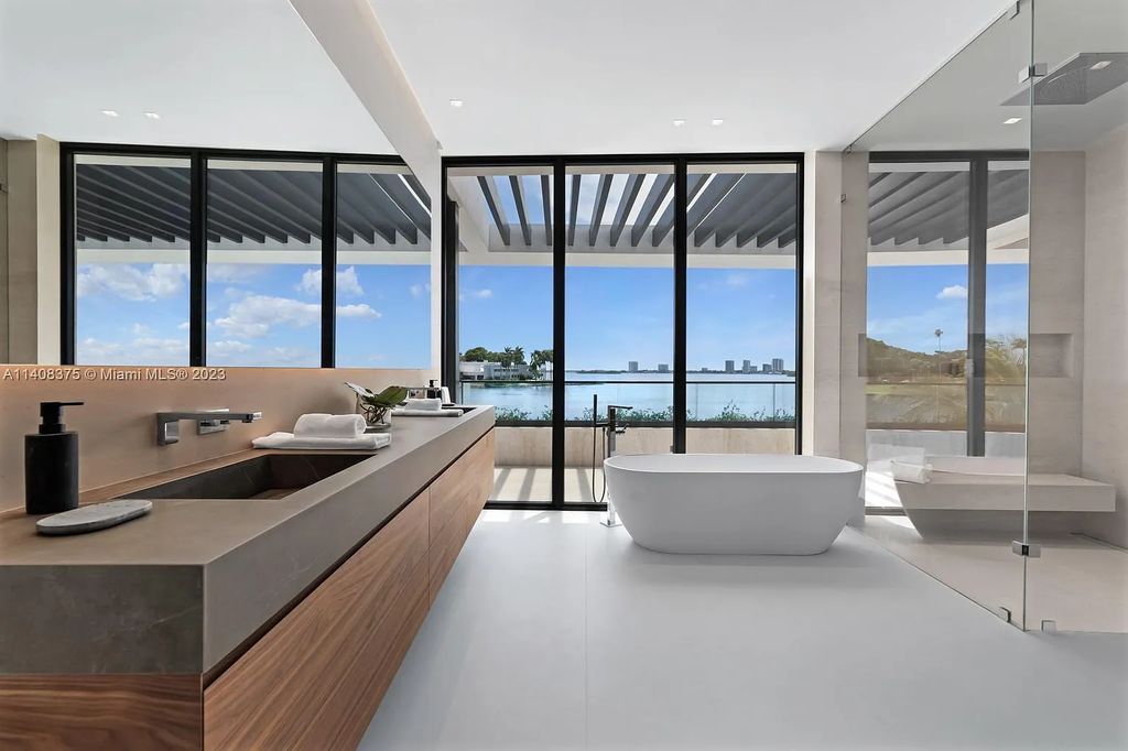 Experience luxury living at its finest in this brand-new custom residence located at 9520 W Broadview Drive, Bay Harbor Islands, Florida. With 8 bedrooms, 10 bathrooms, and over 8,200 square feet of meticulously designed living space, this modern home offers breathtaking open bay views and a seamless indoor-outdoor flow.