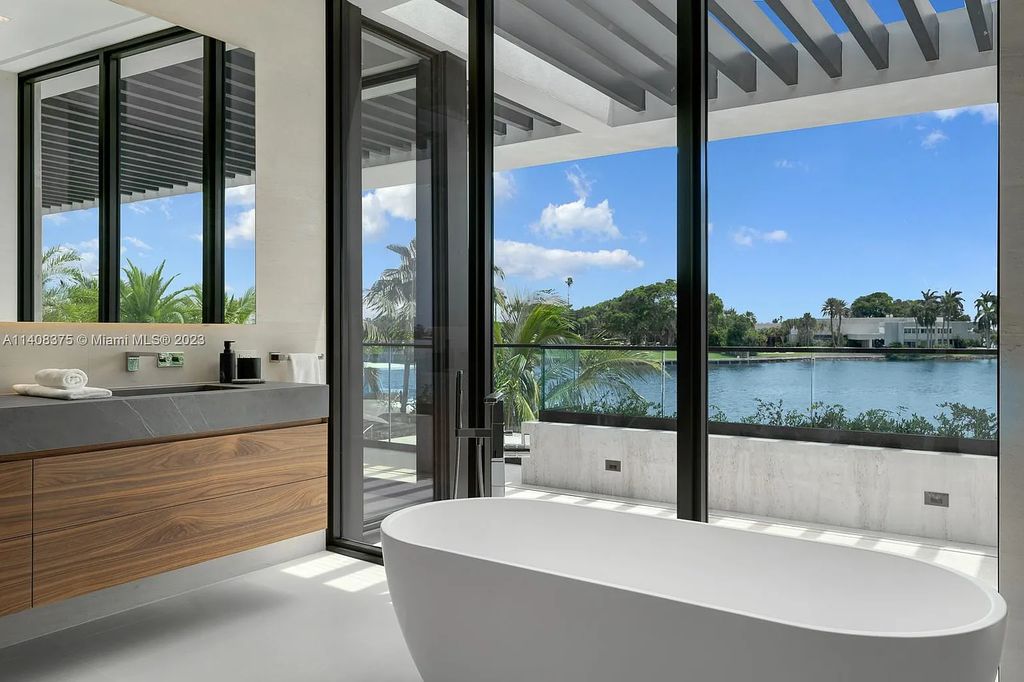 Experience luxury living at its finest in this brand-new custom residence located at 9520 W Broadview Drive, Bay Harbor Islands, Florida. With 8 bedrooms, 10 bathrooms, and over 8,200 square feet of meticulously designed living space, this modern home offers breathtaking open bay views and a seamless indoor-outdoor flow.