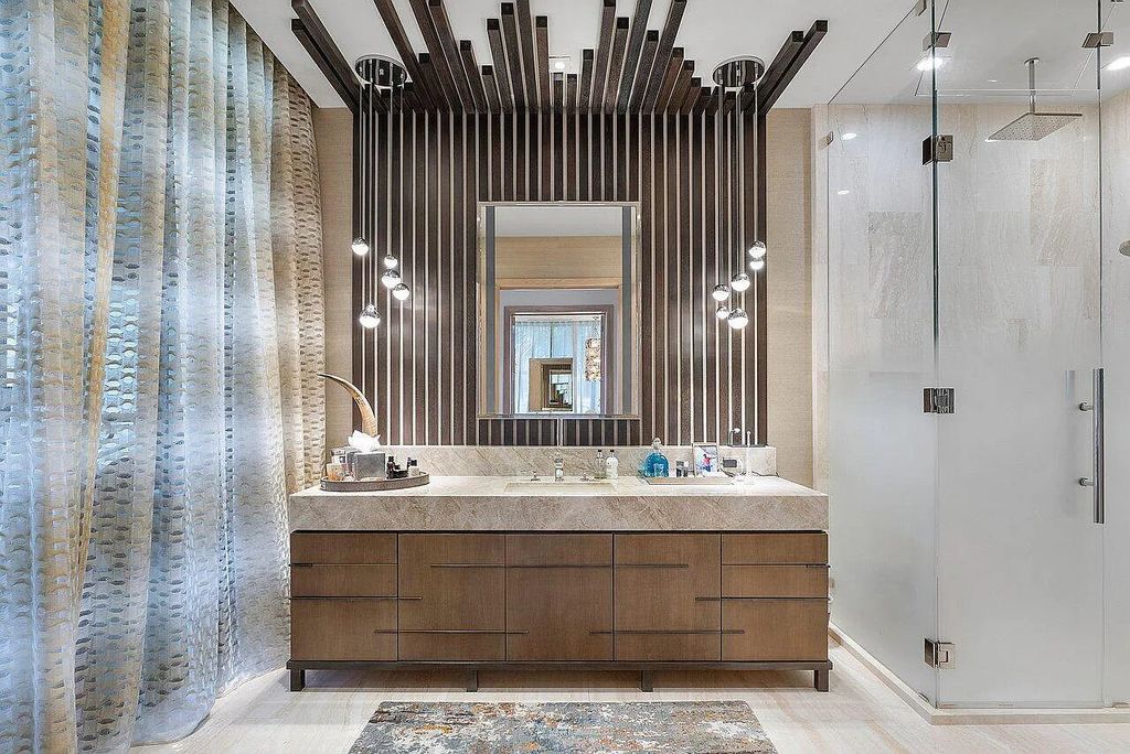 Welcome to 1115 Hillsboro Mile, a luxurious 6-bedrooms, 8-bathrooms home in Hillsboro Beach, Florida. Built in 2017 by Mark Timothy Luxury Homes and Affiniti Architects, this property offers stunning ocean views and a private boat dock.
