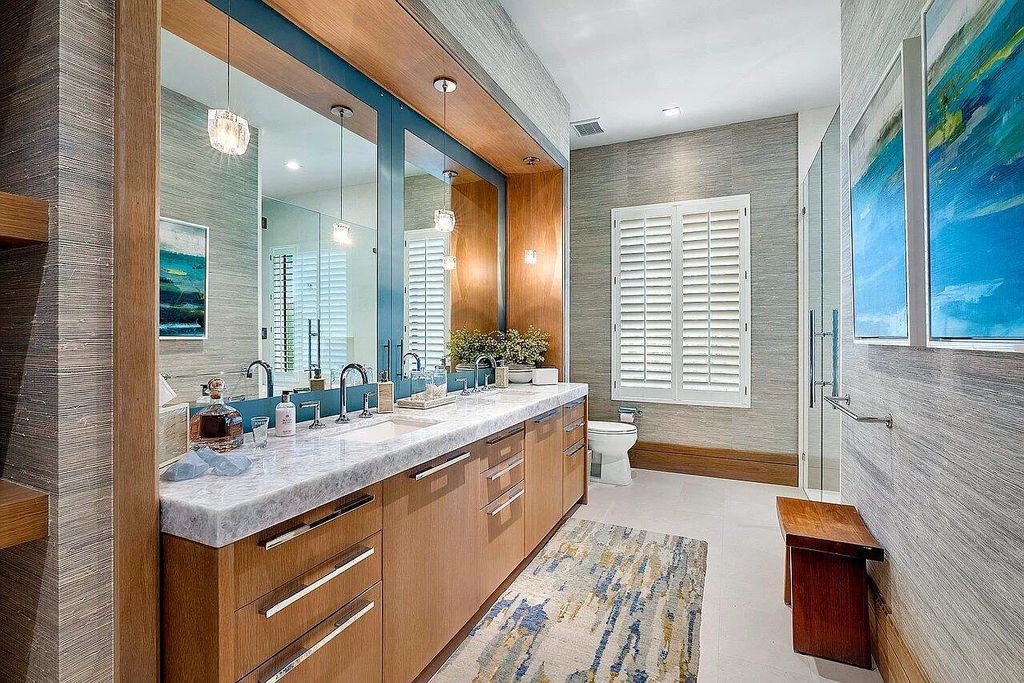 Welcome to 1115 Hillsboro Mile, a luxurious 6-bedrooms, 8-bathrooms home in Hillsboro Beach, Florida. Built in 2017 by Mark Timothy Luxury Homes and Affiniti Architects, this property offers stunning ocean views and a private boat dock.