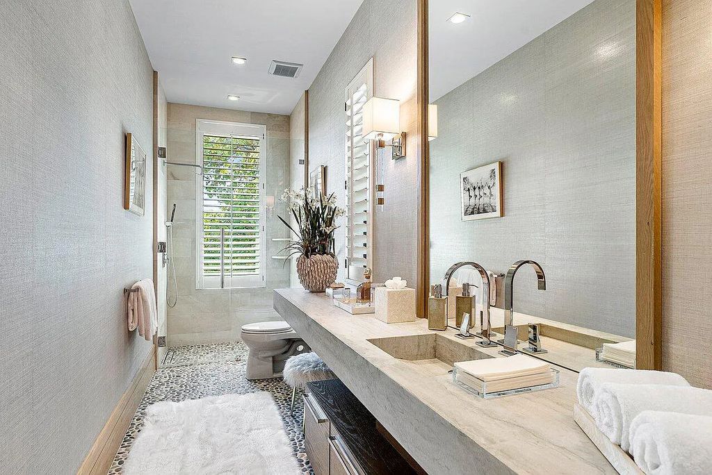 Welcome to 1115 Hillsboro Mile, a luxurious 6-bedrooms, 8-bathrooms home in Hillsboro Beach, Florida. Built in 2017 by Mark Timothy Luxury Homes and Affiniti Architects, this property offers stunning ocean views and a private boat dock.