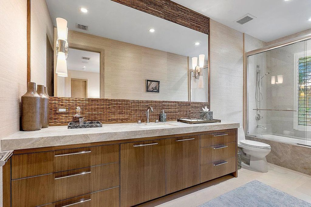 Welcome to 1115 Hillsboro Mile, a luxurious 6-bedrooms, 8-bathrooms home in Hillsboro Beach, Florida. Built in 2017 by Mark Timothy Luxury Homes and Affiniti Architects, this property offers stunning ocean views and a private boat dock.
