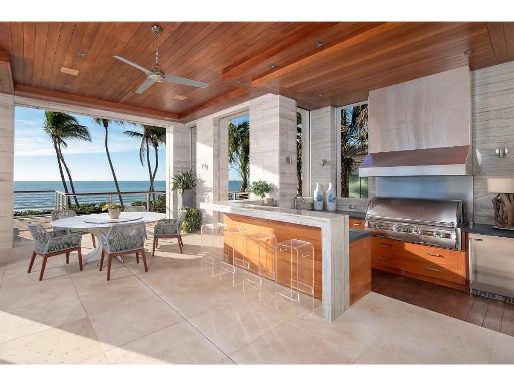 Introducing 25 16th Avenue S, a magnificent beachfront estate in Naples, Florida. This modern masterpiece, designed by Stofft Cooney Architects, LLC and constructed by Newbury North Associates, Inc., offers captivating views of Naples beach and the Gulf of Mexico.