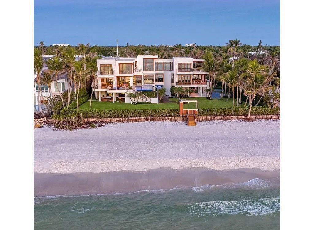 Introducing 25 16th Avenue S, a magnificent beachfront estate in Naples, Florida. This modern masterpiece, designed by Stofft Cooney Architects, LLC and constructed by Newbury North Associates, Inc., offers captivating views of Naples beach and the Gulf of Mexico.