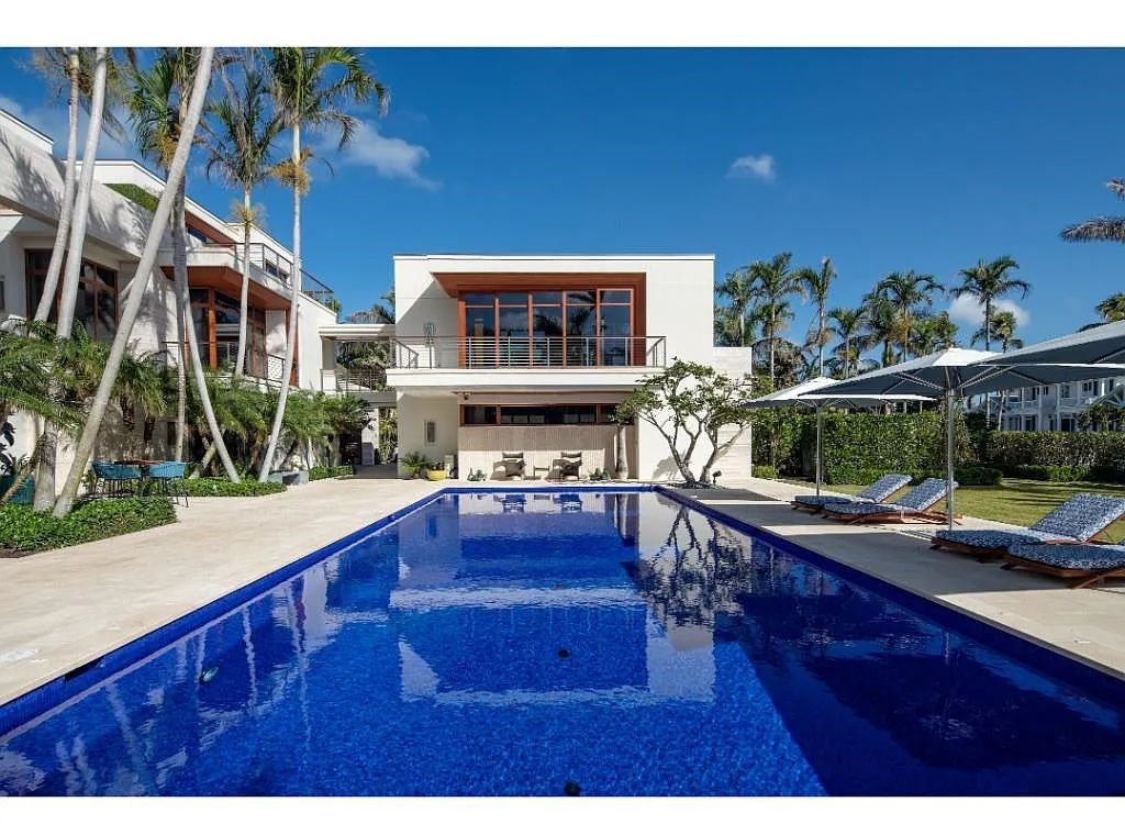Introducing 25 16th Avenue S, a magnificent beachfront estate in Naples, Florida. This modern masterpiece, designed by Stofft Cooney Architects, LLC and constructed by Newbury North Associates, Inc., offers captivating views of Naples beach and the Gulf of Mexico.
