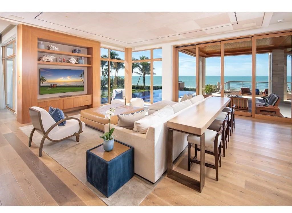 Introducing 25 16th Avenue S, a magnificent beachfront estate in Naples, Florida. This modern masterpiece, designed by Stofft Cooney Architects, LLC and constructed by Newbury North Associates, Inc., offers captivating views of Naples beach and the Gulf of Mexico.