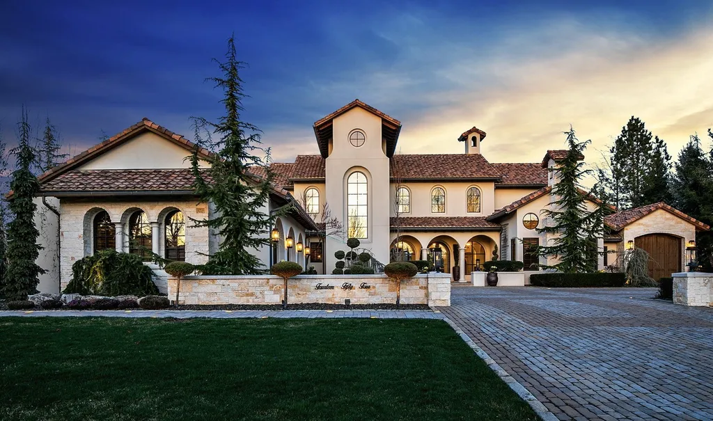 1454 S Heron Pointe Lane Home in Eagle, Idaho. Discover the epitome of luxury and quality in this exceptional Santa Barbara style custom home. Built by renowned Northern Construction and designed by acclaimed architect Trey Hoff, this 1.5-acre waterfront property boasts stunning Spanish Colonial architecture. Step into a world of elegance with an infinity pool, spa, and covered outdoor living area featuring custom sound, heaters, televisions, fireplace, and lighting.