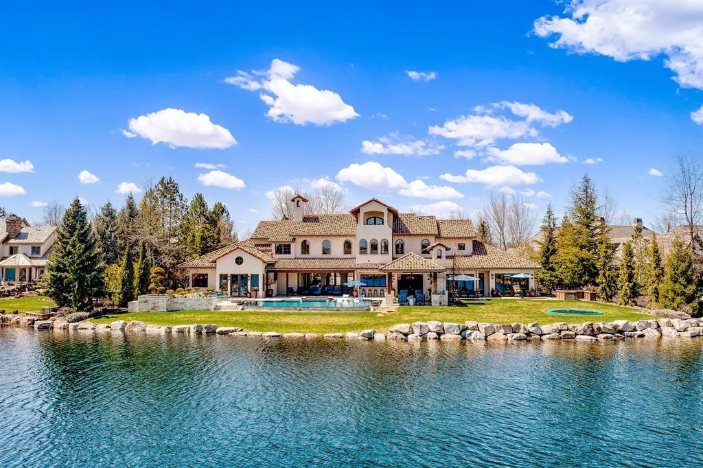 1454 S Heron Pointe Lane Home in Eagle, Idaho. Discover the epitome of luxury and quality in this exceptional Santa Barbara style custom home. Built by renowned Northern Construction and designed by acclaimed architect Trey Hoff, this 1.5-acre waterfront property boasts stunning Spanish Colonial architecture. Step into a world of elegance with an infinity pool, spa, and covered outdoor living area featuring custom sound, heaters, televisions, fireplace, and lighting.