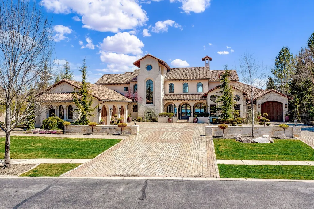 1454 S Heron Pointe Lane Home in Eagle, Idaho. Discover the epitome of luxury and quality in this exceptional Santa Barbara style custom home. Built by renowned Northern Construction and designed by acclaimed architect Trey Hoff, this 1.5-acre waterfront property boasts stunning Spanish Colonial architecture. Step into a world of elegance with an infinity pool, spa, and covered outdoor living area featuring custom sound, heaters, televisions, fireplace, and lighting.