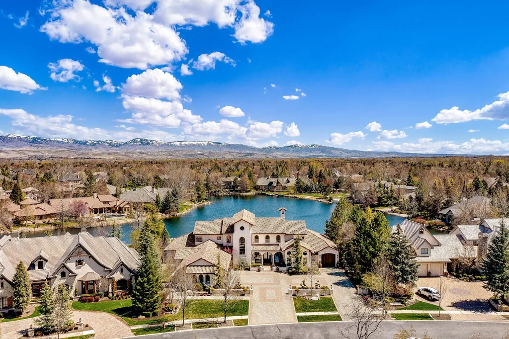 1454 S Heron Pointe Lane Home in Eagle, Idaho. Discover the epitome of luxury and quality in this exceptional Santa Barbara style custom home. Built by renowned Northern Construction and designed by acclaimed architect Trey Hoff, this 1.5-acre waterfront property boasts stunning Spanish Colonial architecture. Step into a world of elegance with an infinity pool, spa, and covered outdoor living area featuring custom sound, heaters, televisions, fireplace, and lighting.