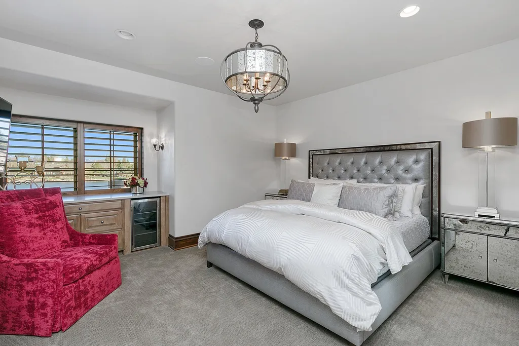 1454 S Heron Pointe Lane Home in Eagle, Idaho. Discover the epitome of luxury and quality in this exceptional Santa Barbara style custom home. Built by renowned Northern Construction and designed by acclaimed architect Trey Hoff, this 1.5-acre waterfront property boasts stunning Spanish Colonial architecture. Step into a world of elegance with an infinity pool, spa, and covered outdoor living area featuring custom sound, heaters, televisions, fireplace, and lighting.