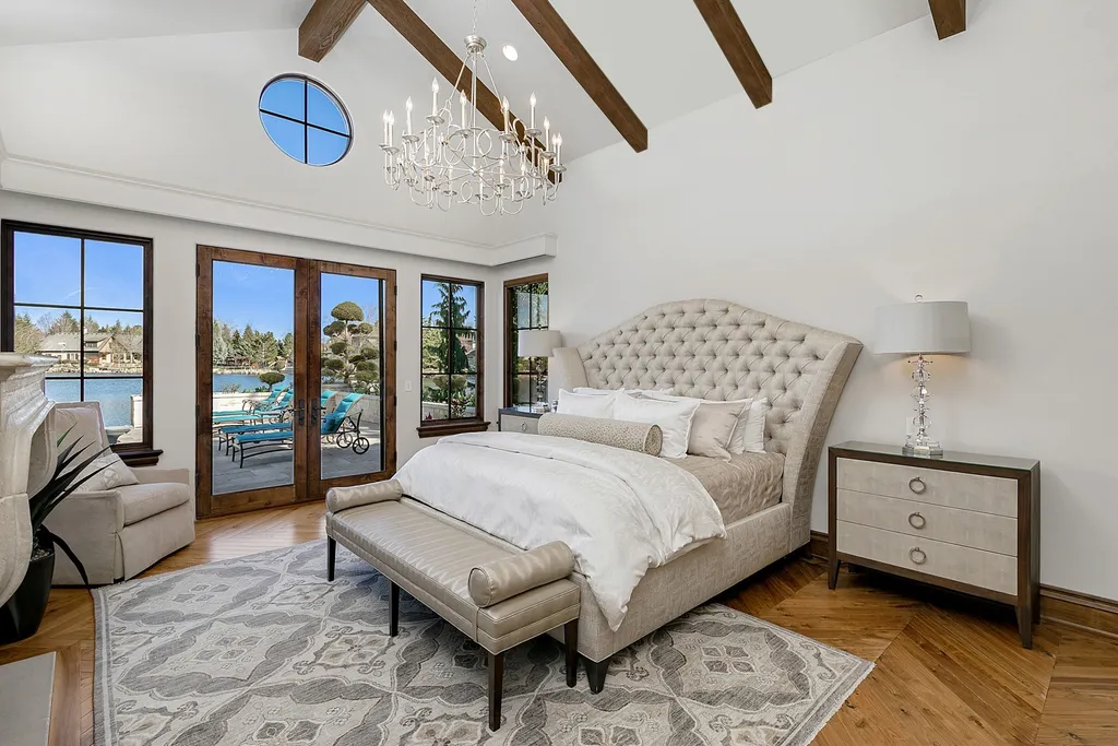 1454 S Heron Pointe Lane Home in Eagle, Idaho. Discover the epitome of luxury and quality in this exceptional Santa Barbara style custom home. Built by renowned Northern Construction and designed by acclaimed architect Trey Hoff, this 1.5-acre waterfront property boasts stunning Spanish Colonial architecture. Step into a world of elegance with an infinity pool, spa, and covered outdoor living area featuring custom sound, heaters, televisions, fireplace, and lighting.