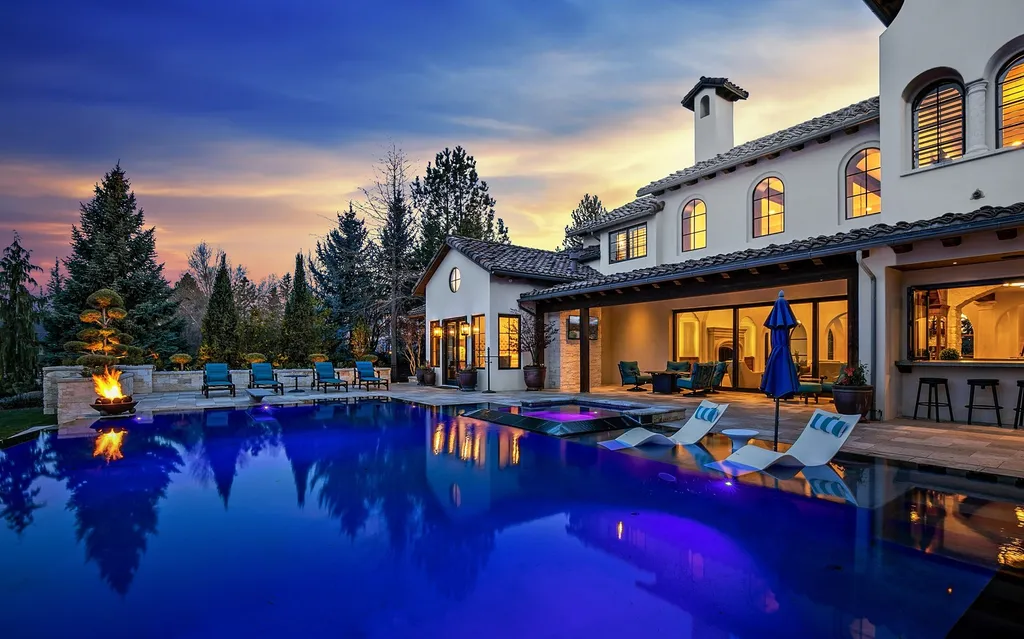1454 S Heron Pointe Lane Home in Eagle, Idaho. Discover the epitome of luxury and quality in this exceptional Santa Barbara style custom home. Built by renowned Northern Construction and designed by acclaimed architect Trey Hoff, this 1.5-acre waterfront property boasts stunning Spanish Colonial architecture. Step into a world of elegance with an infinity pool, spa, and covered outdoor living area featuring custom sound, heaters, televisions, fireplace, and lighting.