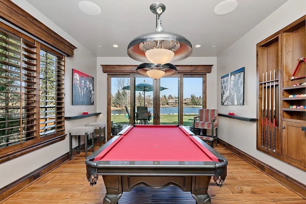 1454 S Heron Pointe Lane Home in Eagle, Idaho. Discover the epitome of luxury and quality in this exceptional Santa Barbara style custom home. Built by renowned Northern Construction and designed by acclaimed architect Trey Hoff, this 1.5-acre waterfront property boasts stunning Spanish Colonial architecture. Step into a world of elegance with an infinity pool, spa, and covered outdoor living area featuring custom sound, heaters, televisions, fireplace, and lighting.