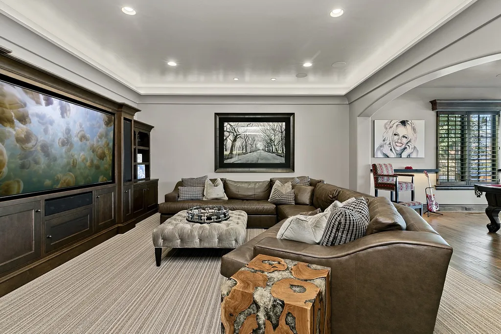 1454 S Heron Pointe Lane Home in Eagle, Idaho. Discover the epitome of luxury and quality in this exceptional Santa Barbara style custom home. Built by renowned Northern Construction and designed by acclaimed architect Trey Hoff, this 1.5-acre waterfront property boasts stunning Spanish Colonial architecture. Step into a world of elegance with an infinity pool, spa, and covered outdoor living area featuring custom sound, heaters, televisions, fireplace, and lighting.