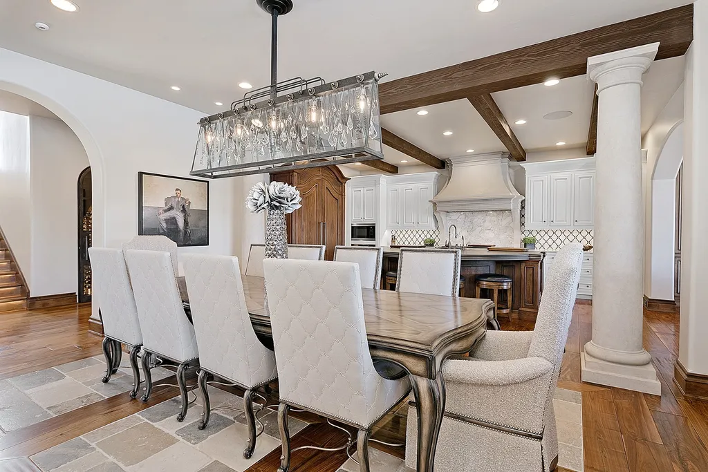 1454 S Heron Pointe Lane Home in Eagle, Idaho. Discover the epitome of luxury and quality in this exceptional Santa Barbara style custom home. Built by renowned Northern Construction and designed by acclaimed architect Trey Hoff, this 1.5-acre waterfront property boasts stunning Spanish Colonial architecture. Step into a world of elegance with an infinity pool, spa, and covered outdoor living area featuring custom sound, heaters, televisions, fireplace, and lighting.