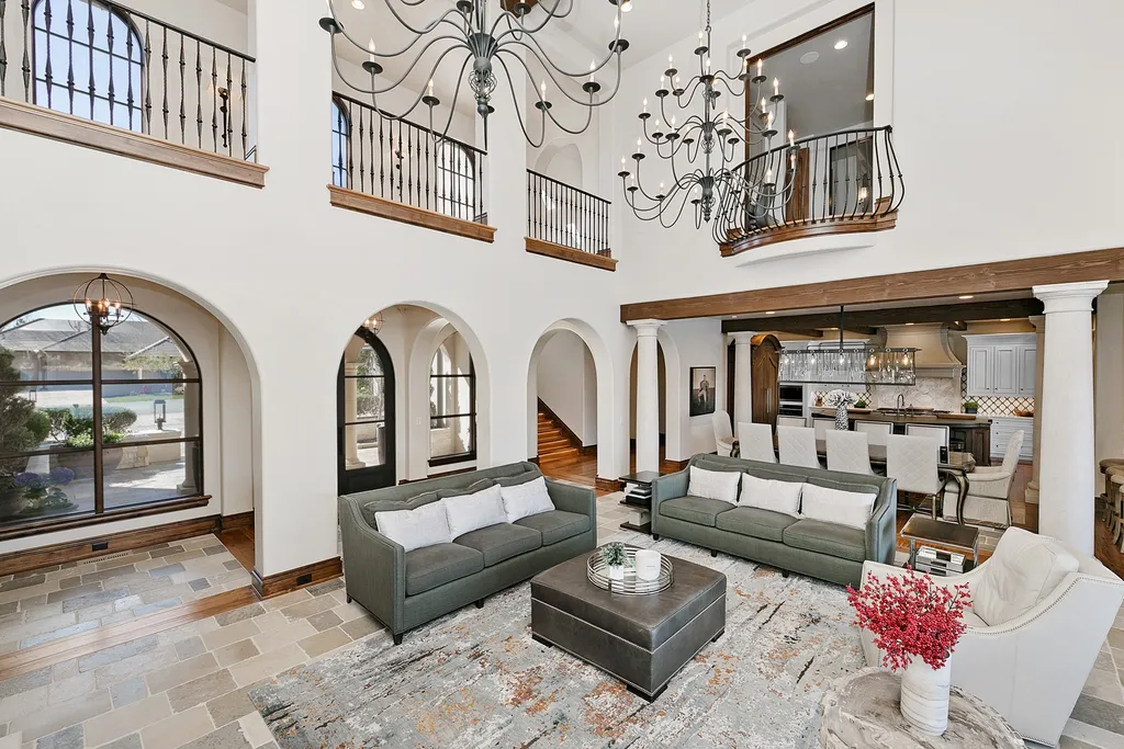 1454 S Heron Pointe Lane Home in Eagle, Idaho. Discover the epitome of luxury and quality in this exceptional Santa Barbara style custom home. Built by renowned Northern Construction and designed by acclaimed architect Trey Hoff, this 1.5-acre waterfront property boasts stunning Spanish Colonial architecture. Step into a world of elegance with an infinity pool, spa, and covered outdoor living area featuring custom sound, heaters, televisions, fireplace, and lighting.