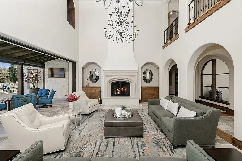 1454 S Heron Pointe Lane Home in Eagle, Idaho. Discover the epitome of luxury and quality in this exceptional Santa Barbara style custom home. Built by renowned Northern Construction and designed by acclaimed architect Trey Hoff, this 1.5-acre waterfront property boasts stunning Spanish Colonial architecture. Step into a world of elegance with an infinity pool, spa, and covered outdoor living area featuring custom sound, heaters, televisions, fireplace, and lighting.