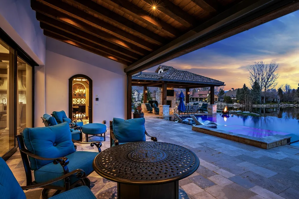 1454 S Heron Pointe Lane Home in Eagle, Idaho. Discover the epitome of luxury and quality in this exceptional Santa Barbara style custom home. Built by renowned Northern Construction and designed by acclaimed architect Trey Hoff, this 1.5-acre waterfront property boasts stunning Spanish Colonial architecture. Step into a world of elegance with an infinity pool, spa, and covered outdoor living area featuring custom sound, heaters, televisions, fireplace, and lighting.