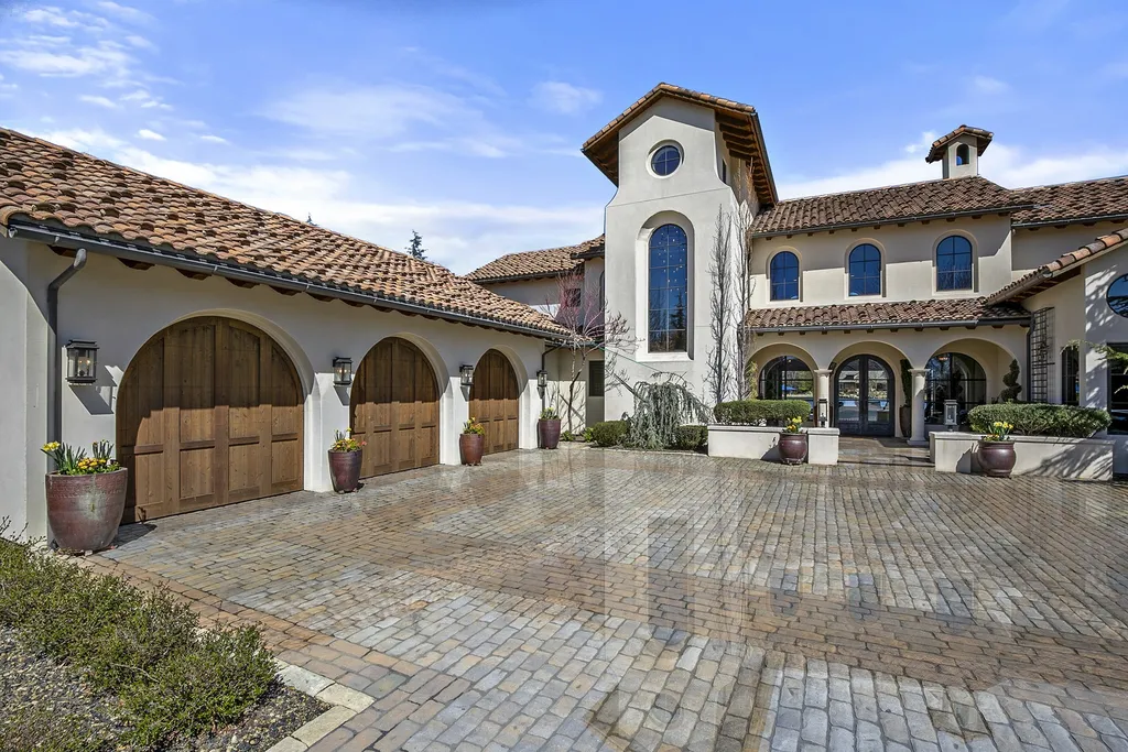 1454 S Heron Pointe Lane Home in Eagle, Idaho. Discover the epitome of luxury and quality in this exceptional Santa Barbara style custom home. Built by renowned Northern Construction and designed by acclaimed architect Trey Hoff, this 1.5-acre waterfront property boasts stunning Spanish Colonial architecture. Step into a world of elegance with an infinity pool, spa, and covered outdoor living area featuring custom sound, heaters, televisions, fireplace, and lighting.