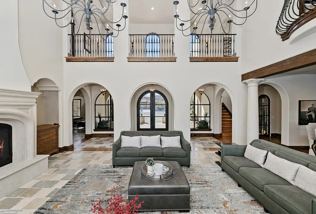 1454 S Heron Pointe Lane Home in Eagle, Idaho. Discover the epitome of luxury and quality in this exceptional Santa Barbara style custom home. Built by renowned Northern Construction and designed by acclaimed architect Trey Hoff, this 1.5-acre waterfront property boasts stunning Spanish Colonial architecture. Step into a world of elegance with an infinity pool, spa, and covered outdoor living area featuring custom sound, heaters, televisions, fireplace, and lighting.