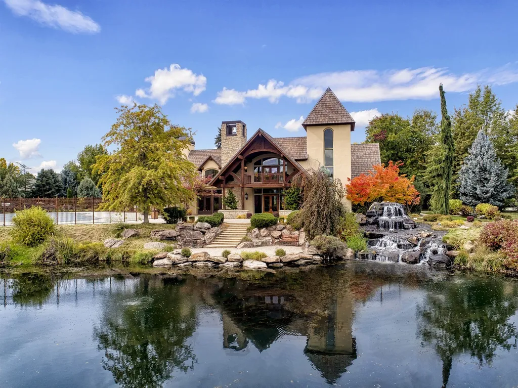 1454 S Heron Pointe Lane Home in Eagle, Idaho. Discover the epitome of luxury and quality in this exceptional Santa Barbara style custom home. Built by renowned Northern Construction and designed by acclaimed architect Trey Hoff, this 1.5-acre waterfront property boasts stunning Spanish Colonial architecture. Step into a world of elegance with an infinity pool, spa, and covered outdoor living area featuring custom sound, heaters, televisions, fireplace, and lighting.
