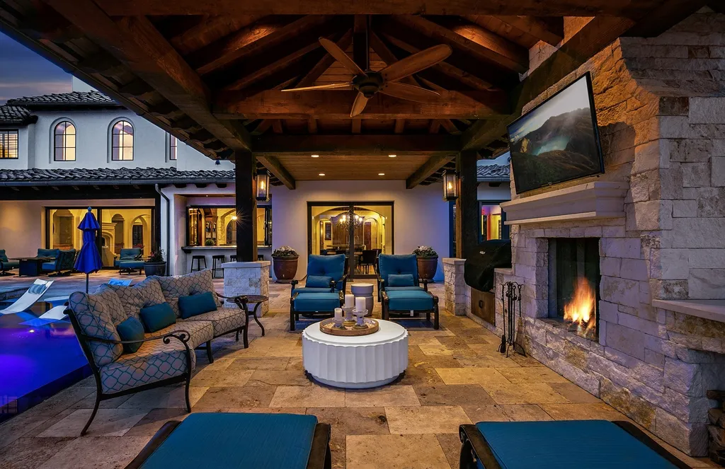 1454 S Heron Pointe Lane Home in Eagle, Idaho. Discover the epitome of luxury and quality in this exceptional Santa Barbara style custom home. Built by renowned Northern Construction and designed by acclaimed architect Trey Hoff, this 1.5-acre waterfront property boasts stunning Spanish Colonial architecture. Step into a world of elegance with an infinity pool, spa, and covered outdoor living area featuring custom sound, heaters, televisions, fireplace, and lighting.