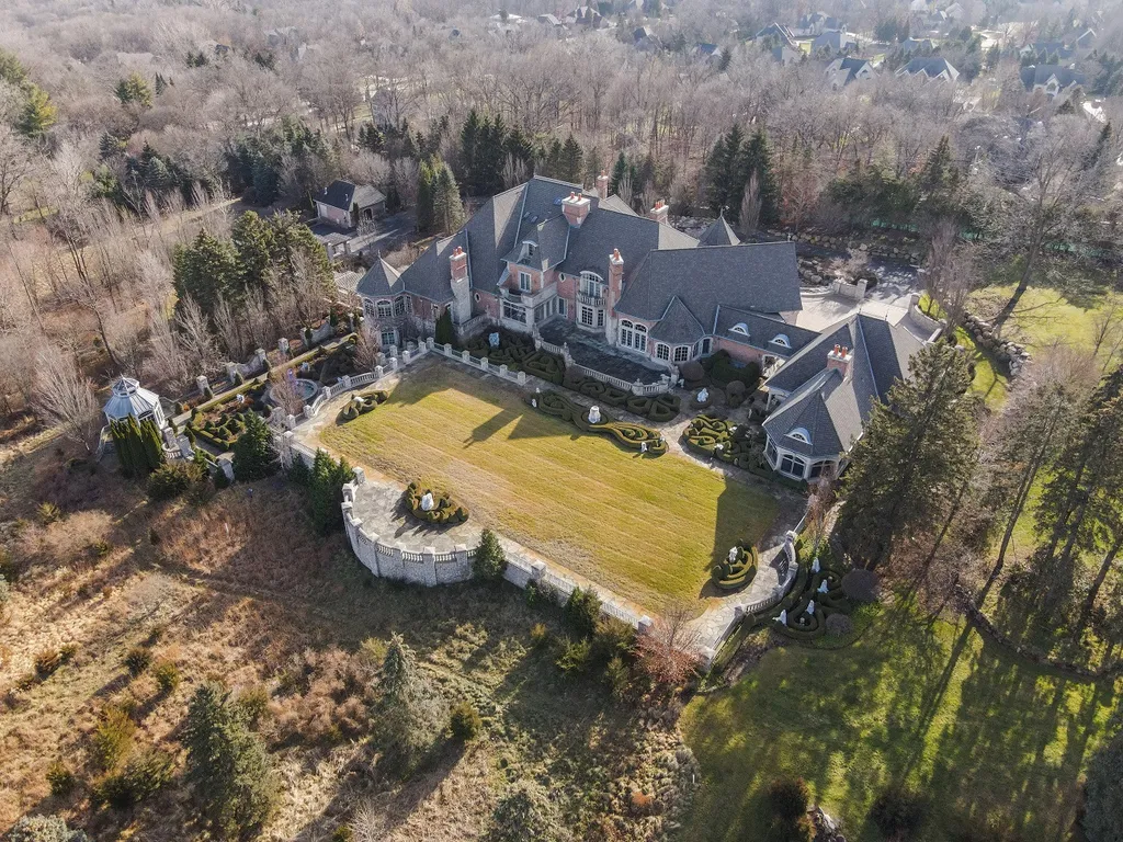 1558 Dutton Road Home in Rochester, Michigan. Discover the epitome of luxury living at this Country Estate in Oakland Township. Spread across 22 acres, the home features hand-carved wooden archways, hand-painted ceiling frescos, and hand-cut stone and gold-leafed accents.